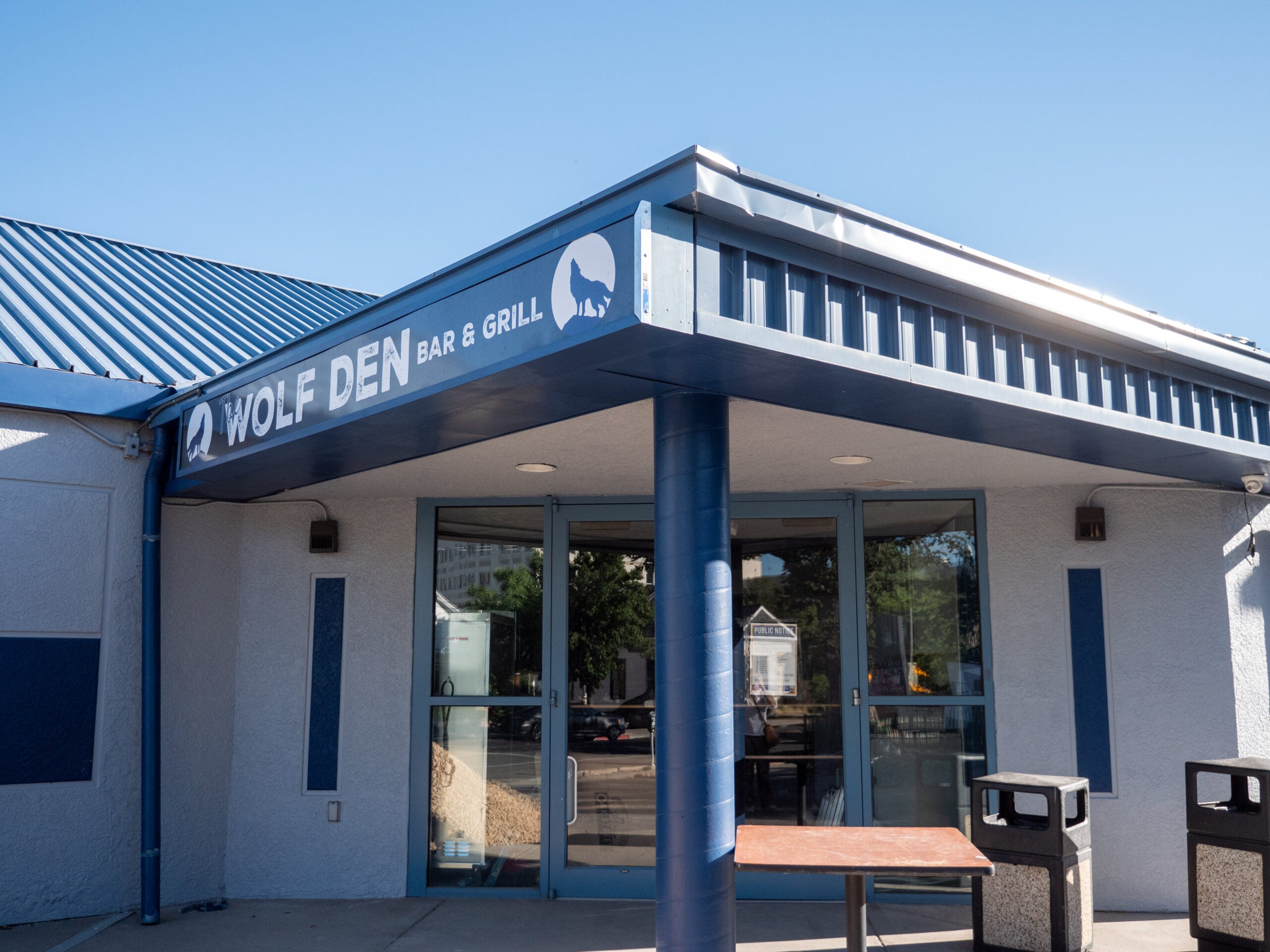 Small retail building with blue awning